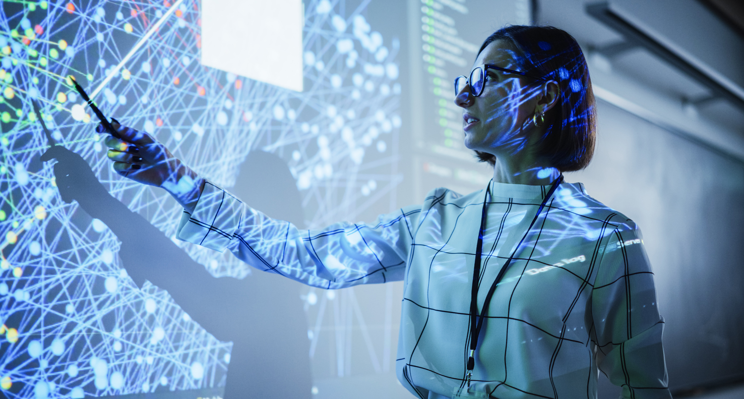 Professional pointing at a large neural network data visualisation display